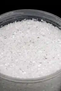 Magnesium Sulphate (Epsom Salt) granules in a clear bowl.