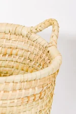 Decorative medium plant basket with handles showing detailed rope-style palm texture.