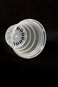 Close-up of transparent net pot with vertical airflow slots.