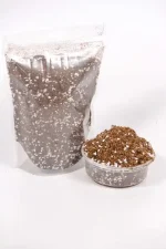 Side view showing fluffy peat and white perlite particles.