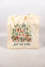 Cotton tote bag with illustrated plant shelf and “Just One More” text.