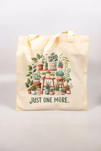 Cotton tote bag with illustrated plant shelf and “Just One More” text.